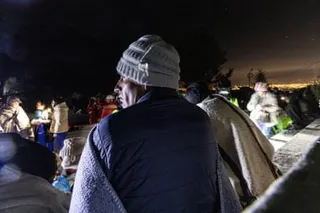 Wearing woolly hats and with blankets around them, residents gather in the main square of in Chupuro following the earthquake which struck on Saturday evening