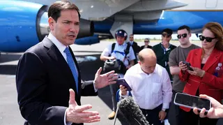 US Secretary of State Marco Rubio speaks to the press in front of a plane