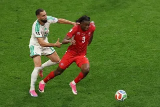 Johan Manzambi (right) of Switzerland is challenged by Nabil Bentaleb of Algeria during a World Cup round of 32 match which the Swiss won 2-0.