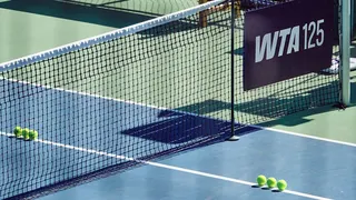 Tennis balls sit on the court during a qualifying match.