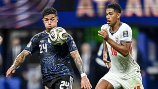 Enzo Fernandez chests the ball as Jude Bellingham chases him