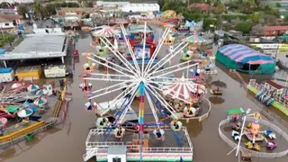 Aerial view of a flooded amusement park including a large ferris wheel.