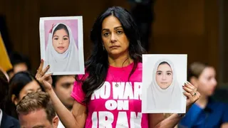 Protesters hold up pictures of Iranian girls at the Senate hearing for Secretary of Defense Pete Hegseth on 21 July 2026