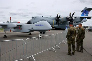 Members of the German air force look at a German Heron TP drone at the International Aerospace Exhibition ILA at Schoenefeld Airport, south of Berlin, in June. Photo: Reuters
