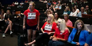 Residents holler at developers during a meeting to discuss a proposed AI data center
