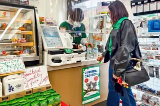 A customer prepares to check out at the register inside a 7-Eleven store in Japan. Photo: Shutterstock