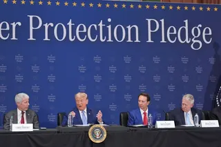 Trump sits at alongside officials at an event announcing ratepayer protections