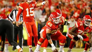 Patrick Mahomes points out defensive coverages with Jordan Devey during a game at Arrowhead Stadium.