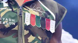 A close-up view of Anthony Joshua's camouflage walk-on outfit, featuring the names Latz and Sina - representing the friends who died in a car crash in December - alongside names of boxing governing bodies