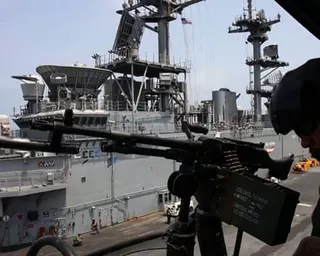 A member of US forces behind a machine gun
