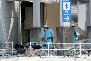 Emergency workers walk through the rubble of the  damaged Aeon Mall on Wednesday. Photo: Reuters