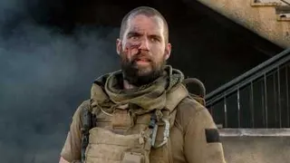 Henry Cavill with shaved head and beard in Sand Castle