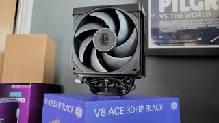 The Cooler Master V8 Ace 3DHP installed on a test bench and on its box.