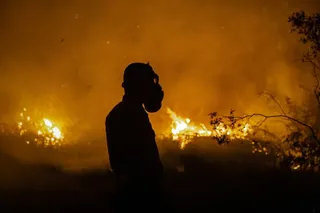OGAN ILIR, SOUTH SUMATRA, INDONESIA - SEPTEMBER 23: A firefighter stands and attempts to extinguish a wildfire on burned peatland and fields on September 23, 2023 in Ogan Ilir, South Sumatra, Indonesia. At least six provinces in the country are battling ongoing forest fires as illegal blazes to clear land for agricultural plantation take control causing respiratory illnesses and biodiversity loss. The nation’s meteorology agency forecasted that Indonesia is likely to experience the most severe d