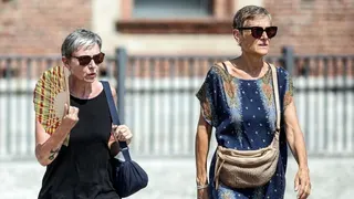 A person uses a fan on a hot summer day in Milan, Italy, 31 July 2026