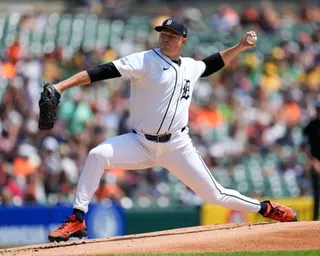 Tigers pitcher Tarik Skubal throws a pitch from the mound in a white uniform
