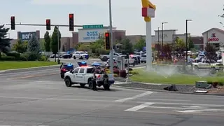 emergency vehicles on street outside shopping mall