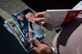 close up of a pair of hands holding a stack of photographs