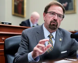 a man in a suit and glasses