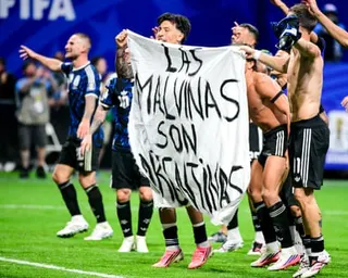 Players of Argentina hold a banner after the World Cup win over England