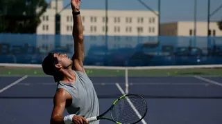 Carlos Alcaraz tosses before a serve during a tennis training session in Murcia, Spain