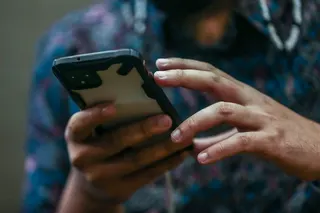 A person holds a smartphone in Kuala Lumpur on May 26, 2022. — Picture by Hari Anggara