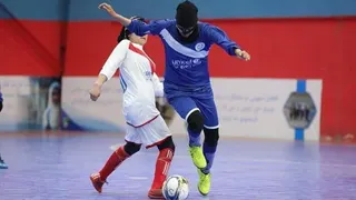 Manozh Noori wearing a face mask to hide her identity while playing a match in Afghanistan