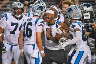 Carolina Panthers tight end Ja'tavion Sanders (center) celebrates with quarterback Haynes King (16) after King scored a touchdown on the last play of the game on Thursday in Canton, Ohio.