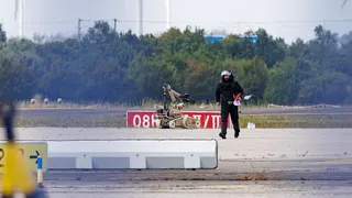A police investigator works on the tarmac at Leipzig/Halle Airport on August 5, 2026, with a robot next to him
