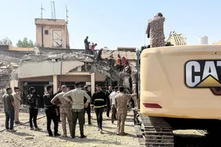 Security forces and emergency personnel work at the site of a strike north of al-Miqdadiyah district in Iraq’s Dayala province on July 29, 2026 [AFP]