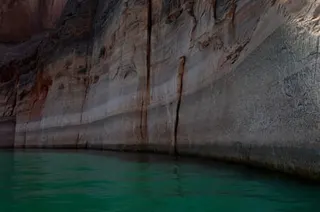 water lines on rocky shore of lake indicating low levels