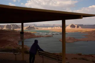 A person stands at an overlook near the Wahweap Marina on Lake Powell at the Glen Canyon National Recreation Area, Tuesday, July 14, 2026, near Page, Ariz. (AP Photo/John Locher)