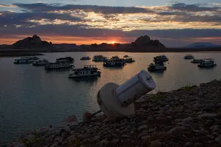 A formerly floating buoy now sits high and dry above Lake Powell at the Glen Canyon National Recreation Area, July 15, 2026, near Page, Nev. (AP Photo/John Locher, File)