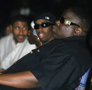 Sean ‘Diddy’ Combs (left) and Christopher ‘The Notorious B.I.G.’ Wallace sitting in a venue