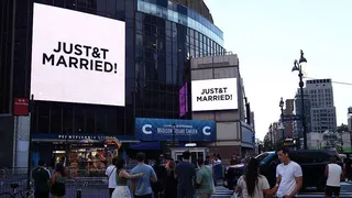 People watch giant screens showing the message "JUST&T MARRIED!" (T&T for Taylor and Travis) outside Madison Square Garden, the reported venue for the wedding celebrations of pop singer Taylor Swift and pro-athlete Travis Kelce, in New York City on July 3, 2026.