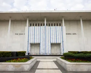 A tarp covers a portion of a building