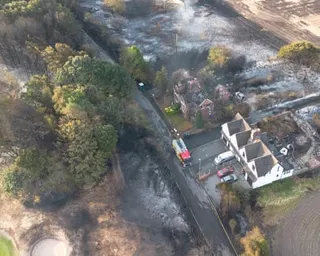 An aerial view shows burnt houses as the wildfire continues to spread to the golf course in Stourbridge, England.