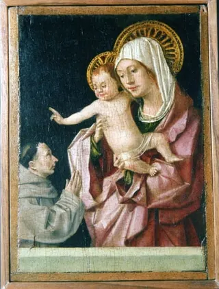 A painting of the Virgin Mary holding the baby Jesus, with a monk on his knees before them