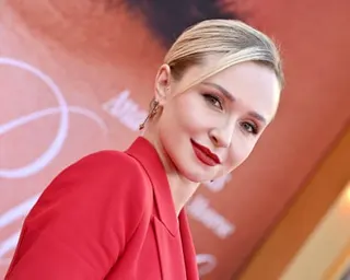 Hayden Panettiere smiles in a red blazer at a film premiere event