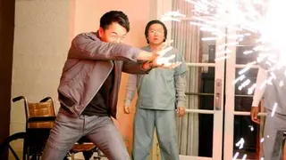 James Kyson Lee blasts a wall with an explosion of sparks as Masi Oka stands by in Heroes