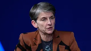 Laura McAllister speaking on a panel, wearing a hands-free microphone