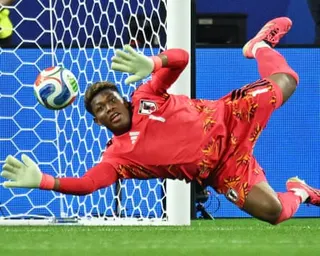 The Japan goalkeeper Zion Suzuki dives to his right to make a save during his team's 2026 men's World Cup group stage game against Sweden in Arlington, Texas.