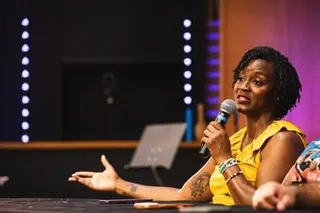 A woman speaks into a microphone
