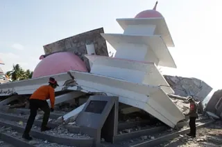 Rescuers inspect the ruins of a mosque that collapsed during an earthquake in North Lamba Leda, East Nusa Tenggara province, Indonesia.