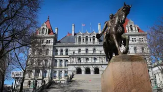 The Albany statehouse with a statue of a horse in front