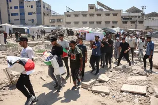 Mourners carry flag-draped body bags containing the remains of Palestinians killed in Israeli strikes during the war with Hamas and recently recovered from the rubble, during a mass funeral in Gaza City on August 20, 2026.
