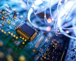 A close of fibre optics passing through an electronic circuit board