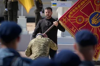 President Volodymyr Zelensky hands over the flag of a military unit during the ceremony to mark Ukraine Independence Day in Kyiv on Monday. Photo: AP