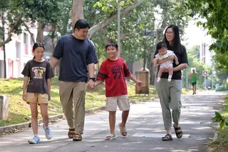 Teo Shu Rong (right) with her husband Desmond Chow (second from left) and their children (from left) Beatrice, Tristan, and Alistair, taking a stroll in Lengkong Tiga on Aug 23.