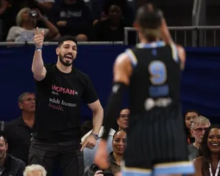 Enes Kanter Freedom, in a "Woman" slogan t-shirt, points and shouts at Natasha Cloud